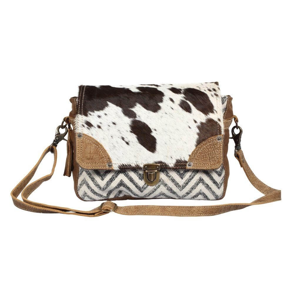 Superior cow-hide leather and rug, hair-on flap masterfully sewed with durable and rugged wash canvas fabric to ensure long lasting durability. 11.5x8.5x3.5