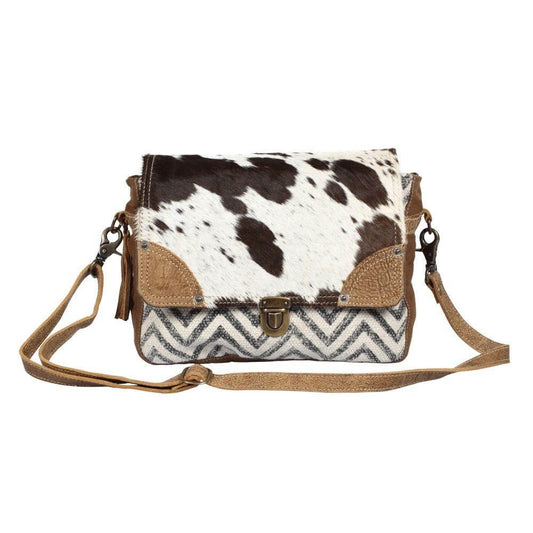 Superior cow-hide leather and rug, hair-on flap masterfully sewed with durable and rugged wash canvas fabric to ensure long lasting durability. 11.5x8.5x3.5