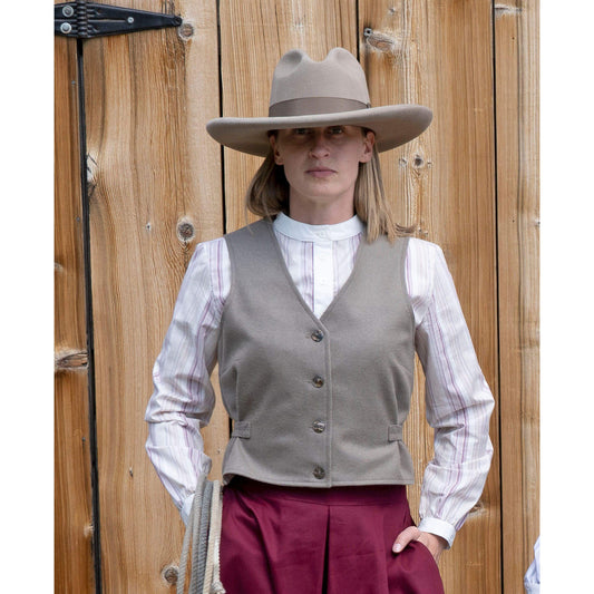 This vest was inspired by the legendary Pearl Hart who was notorious for being a woman bandit who robbed stagecoaches. This vest has elements of masculine design as she dressed up as a man when robbing the stagecoach. A very simple look that can be worn with various outfits. Made of taupe colored Melton-wool and lined in polyester. Adjustable back belt allows for the perfect fit. Pairs great with our Bandit Blouse. Made in USA.