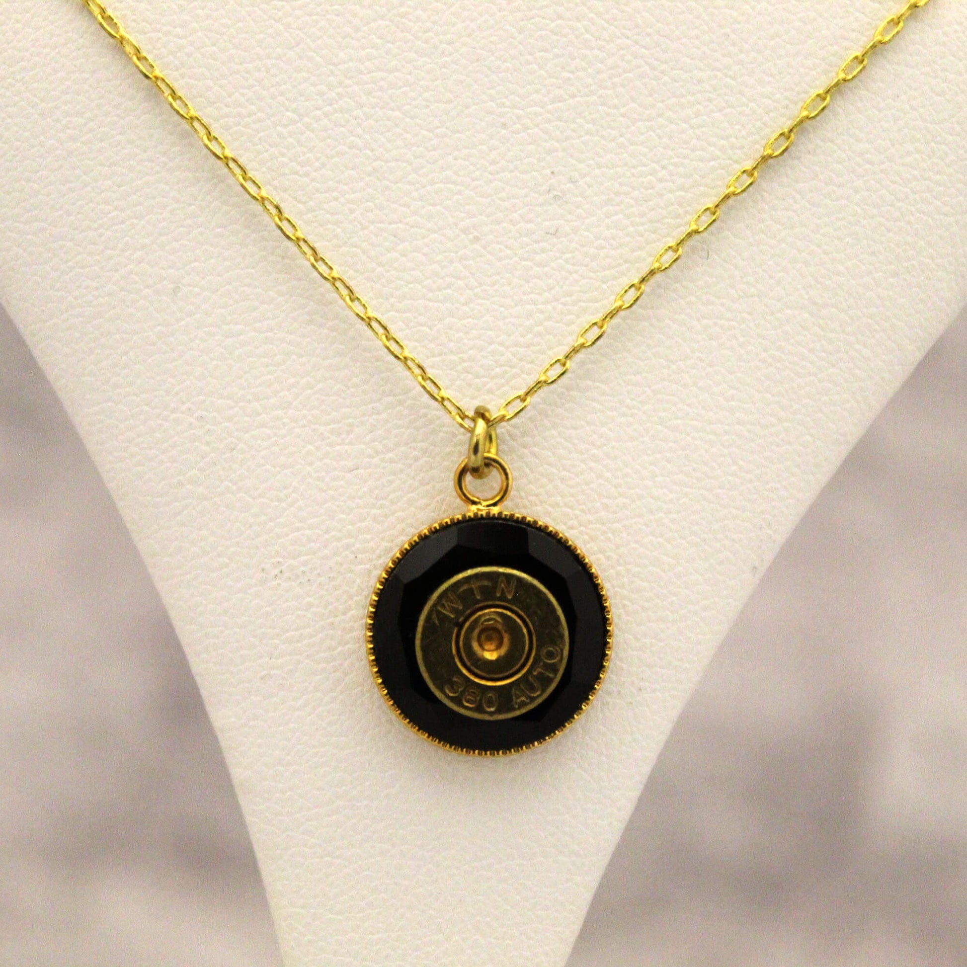 The genuine 38 auto bullet is artfully embedded in Swarovski crystals, transforming danger into dazzling beauty. Wear it close to your heart to channel courage, or show off your sharpshooting skills. The hefty 16-18 inch gold chain gives this medallion necklace a substantial look and feel worthy of your inner warrior. Be daring, be different, be you.