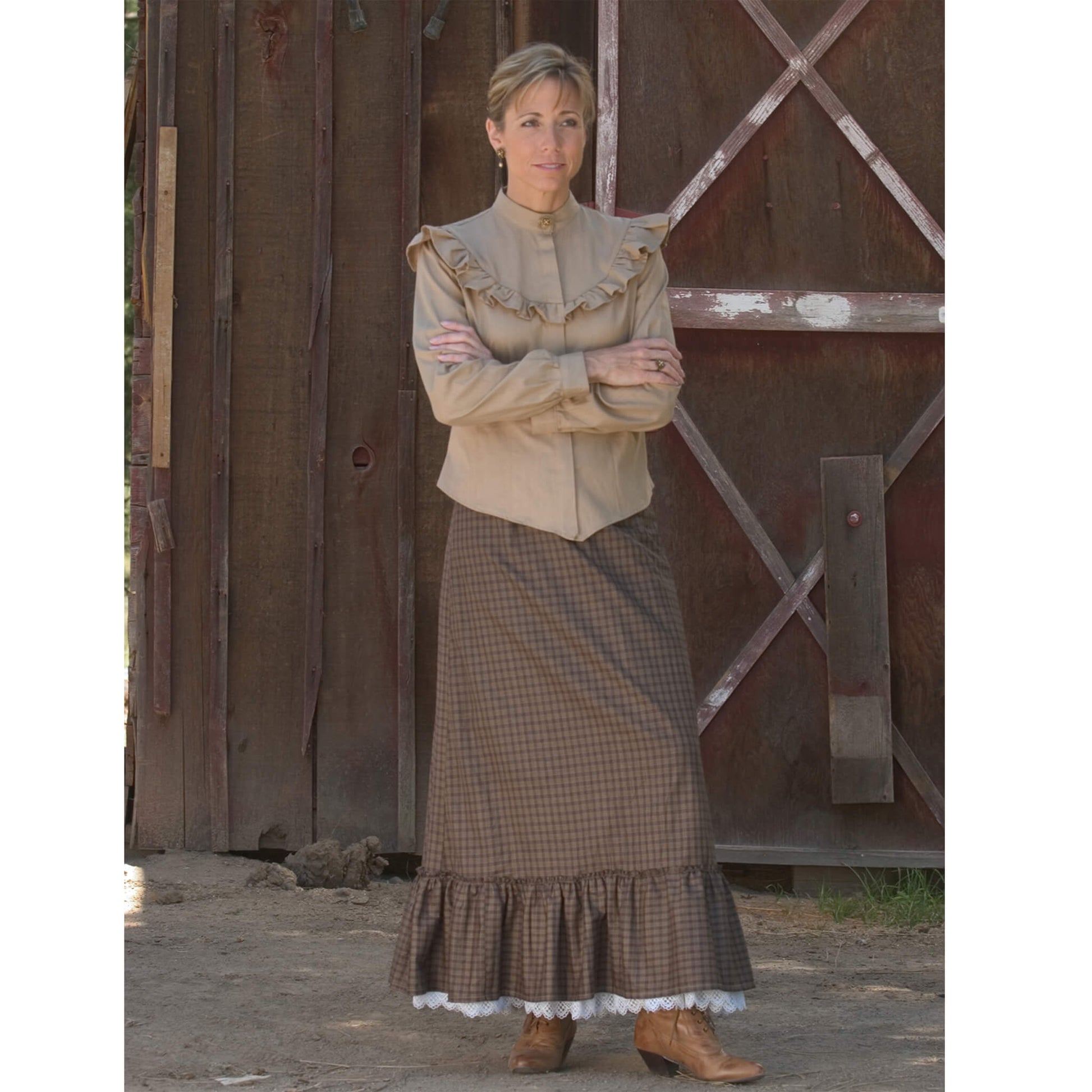 Let the prairie winds bring you back in this simple ruffle skirt. The front gives you a flattering fitted look, while the back comfortably ties giving you a romantic bustle look that gathers and flows. Wear it with our Kate's Prairie Blouse for the complete homestead apparel. Created with 100% hand-loomed cotton plaid. Made in USA