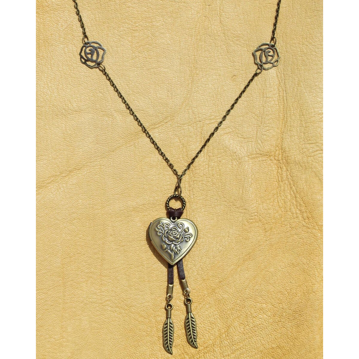 Hold your loved ones close with this open/close heart shaped locket with a detailed rose on an 18” chain that is separated with two rose shaped links on each side. Antique brass-plated. Hand-crafted in the USA.