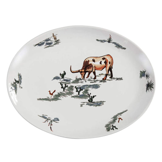 Decorative plate with a cow and birds design on a white background