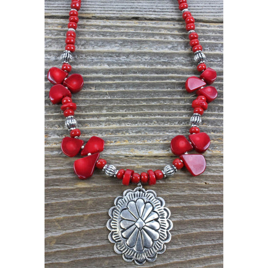 Bamboo coral gems, red and silver beads on a single strand with a silver Concho pendant 1.5″ by 2″. This red stone facilitates intuition, imagination and visualization. Measures 18″ including a 4″ extender and lobster claw clasp. Each piece is unique and may vary slightly.