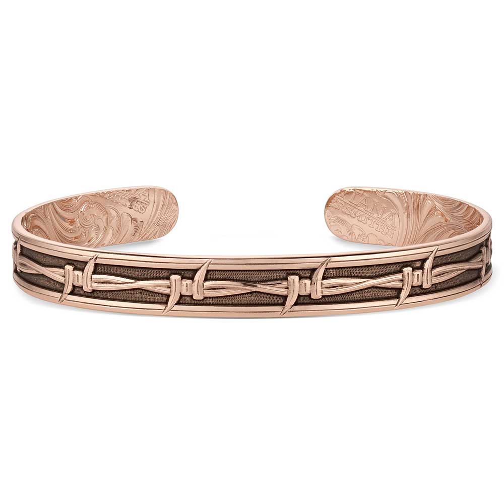Rose gold bracelet with intricate design on a white background