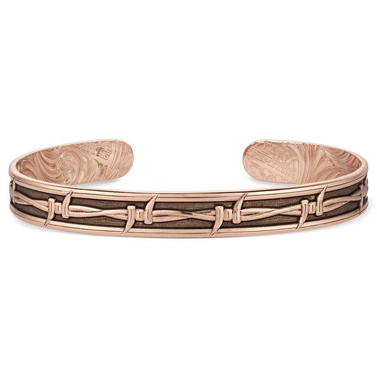Rose gold bracelet with intricate design on a white background