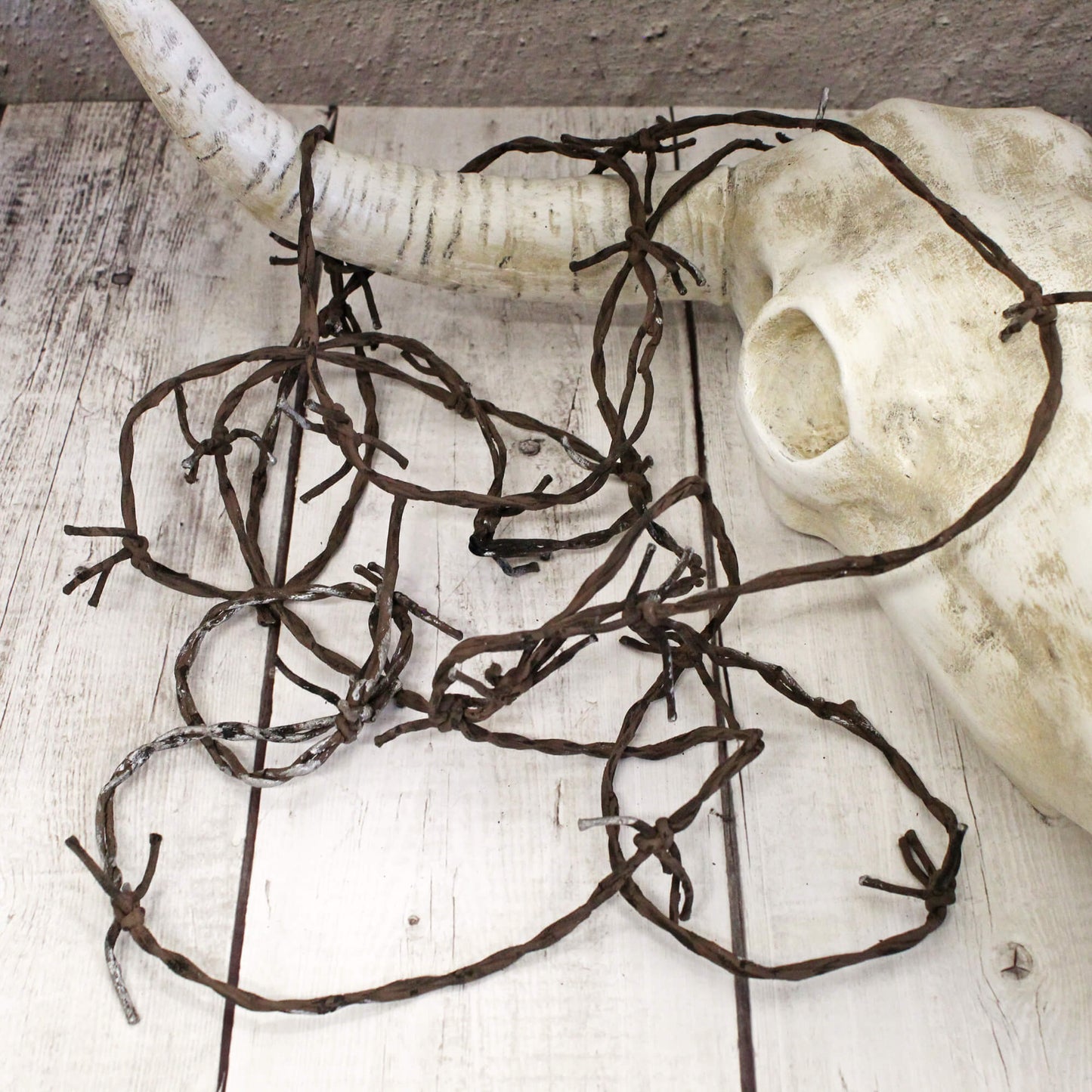 The fake barbed wire is a great outdoor/indoor decoration that adds western rustic touch to any décor or display. The barbed wire has a super realistic look and is made of soft material making it flexible and safe to use. This décor is as versatile as your imagination. Measures 12 feet long.