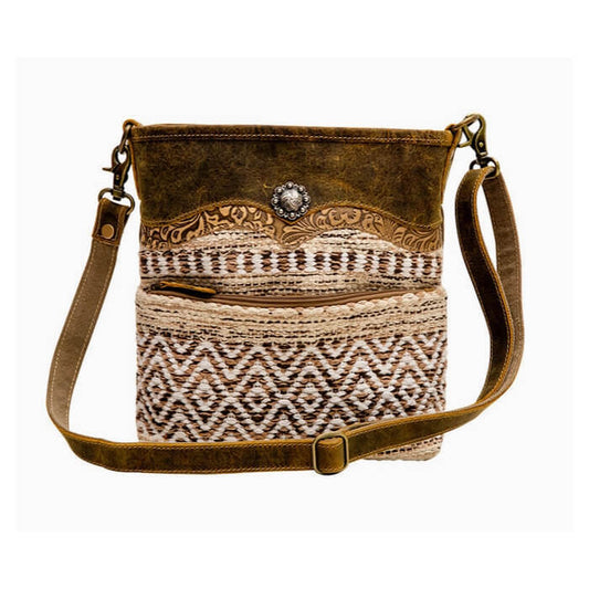 Brown crossbody bag with patterned front pocket on a white background