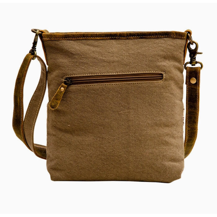 Brown canvas crossbody bag with a strap on a white background