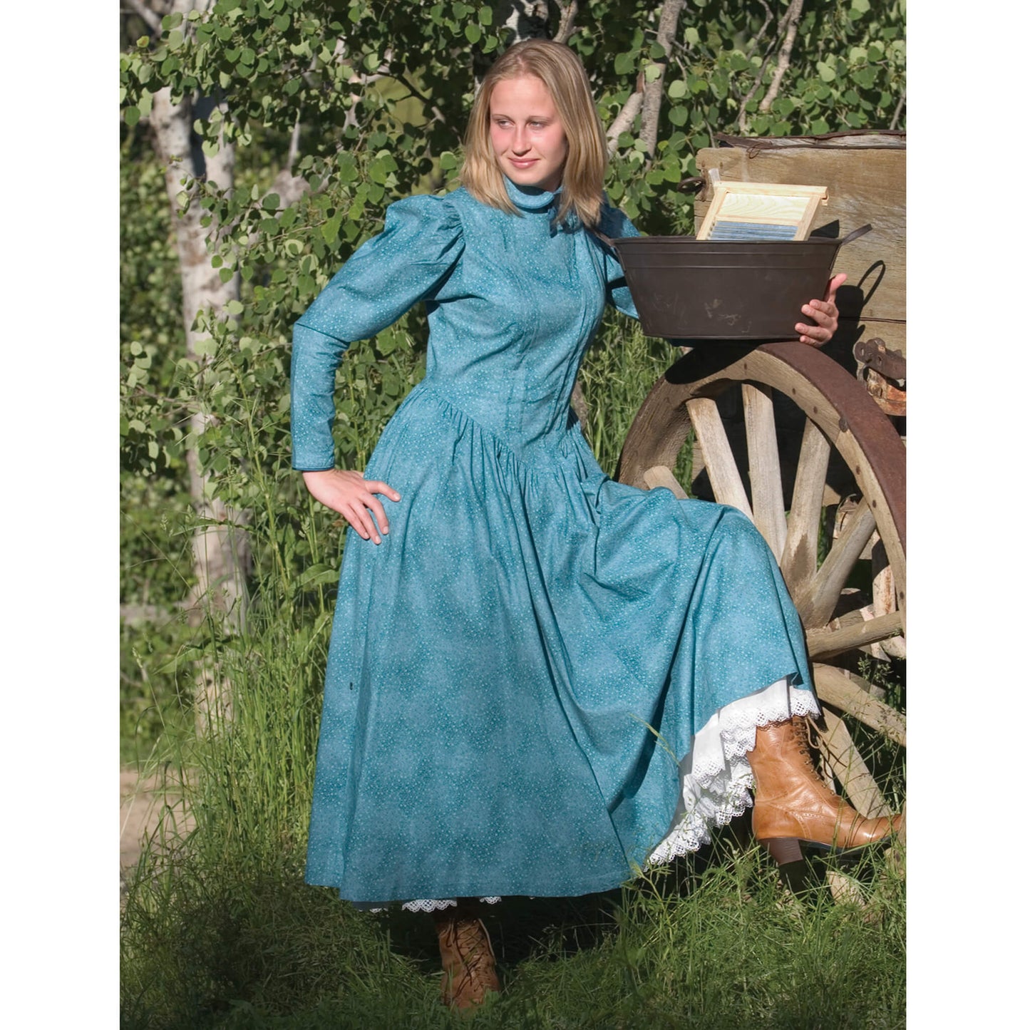 Bring back that classic old-fashioned schoolmarm look when you wear this beauty of a dress. It's prim and proper with a flattering feminine cut that is attractive to different figure types. Offered in 100% cotton calico and trimmed in silk piping for detailing. Front tucks, puffed long sleeves, a dropped front waist, side pockets, and a long back zipper are the design highlights. The skirt is frontier length, approximately 35" from waist.