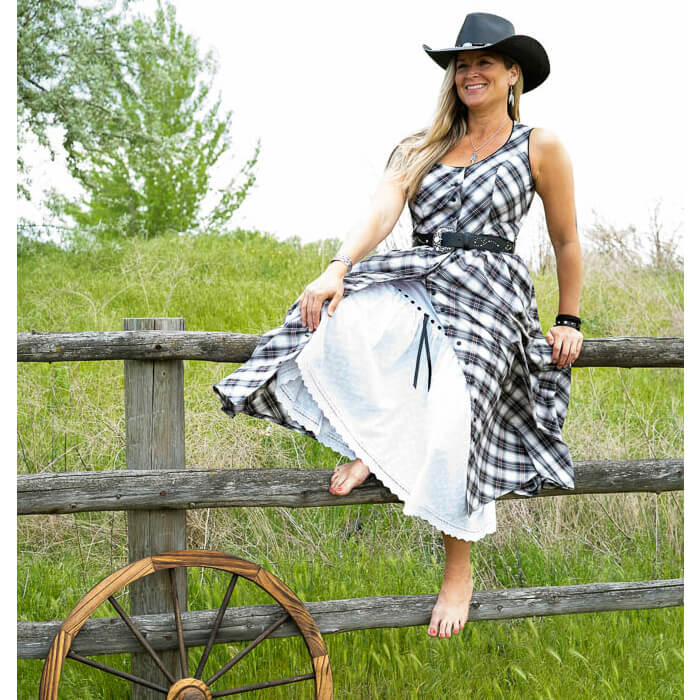 A flirty sundress baring just enough with its button-front and eyelet petticoat (sold separately) peeking out beneath.  Contrast piping trims the neckline and armholes and comes with belt loops around the waist to accommodate a cute belt. Dress is made with a bias cut cotton plaid and bodice is lined for modesty. Measures 31” from waist down. 100% Cotton/Lined in Polyester. Petticoat Sold Separately. Made in USA