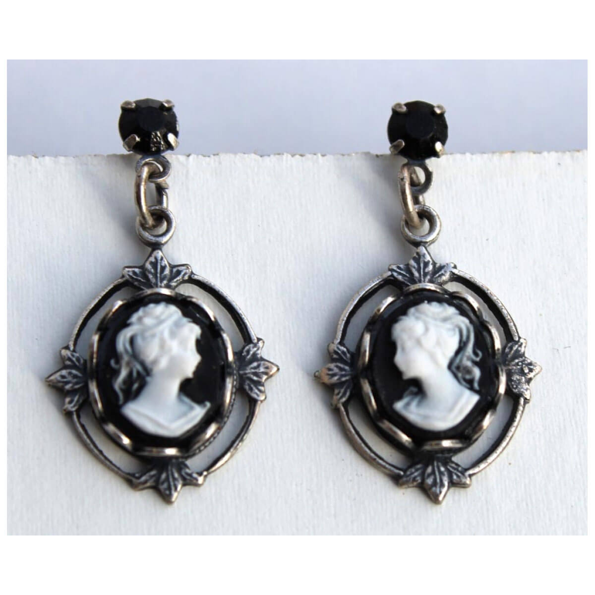 This antique reproduction cameo jewelry gives you a real heirloom look. The cameo drop earrings with bezel set black cameo and jet Austrian crystal hypo-allergenic surgical-steel post. Earrings measure 1-⅛” long by ⅝” wide. Made in USA.