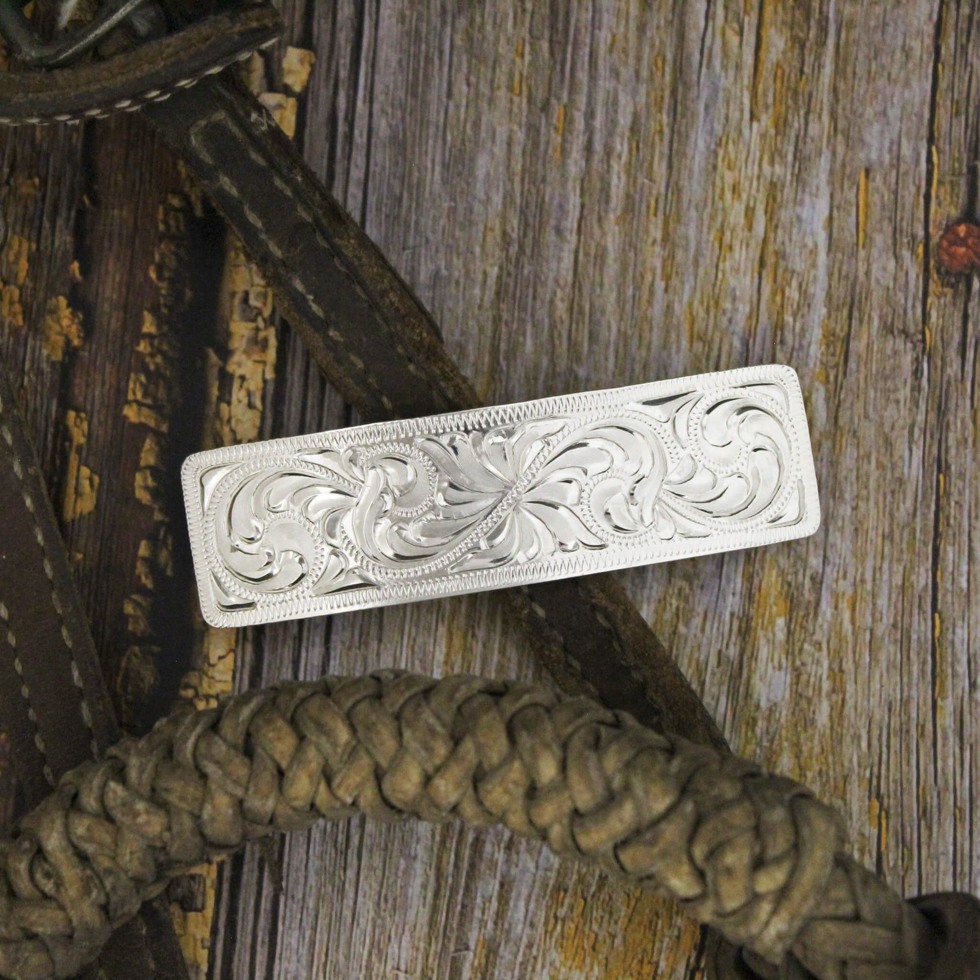 Give your updo some much needed sparkle with this beautiful hair barrette! This rectangular barrette is made of German silver and engraved with a scroll design and French clasp. Measures 3-1/2" by 1".