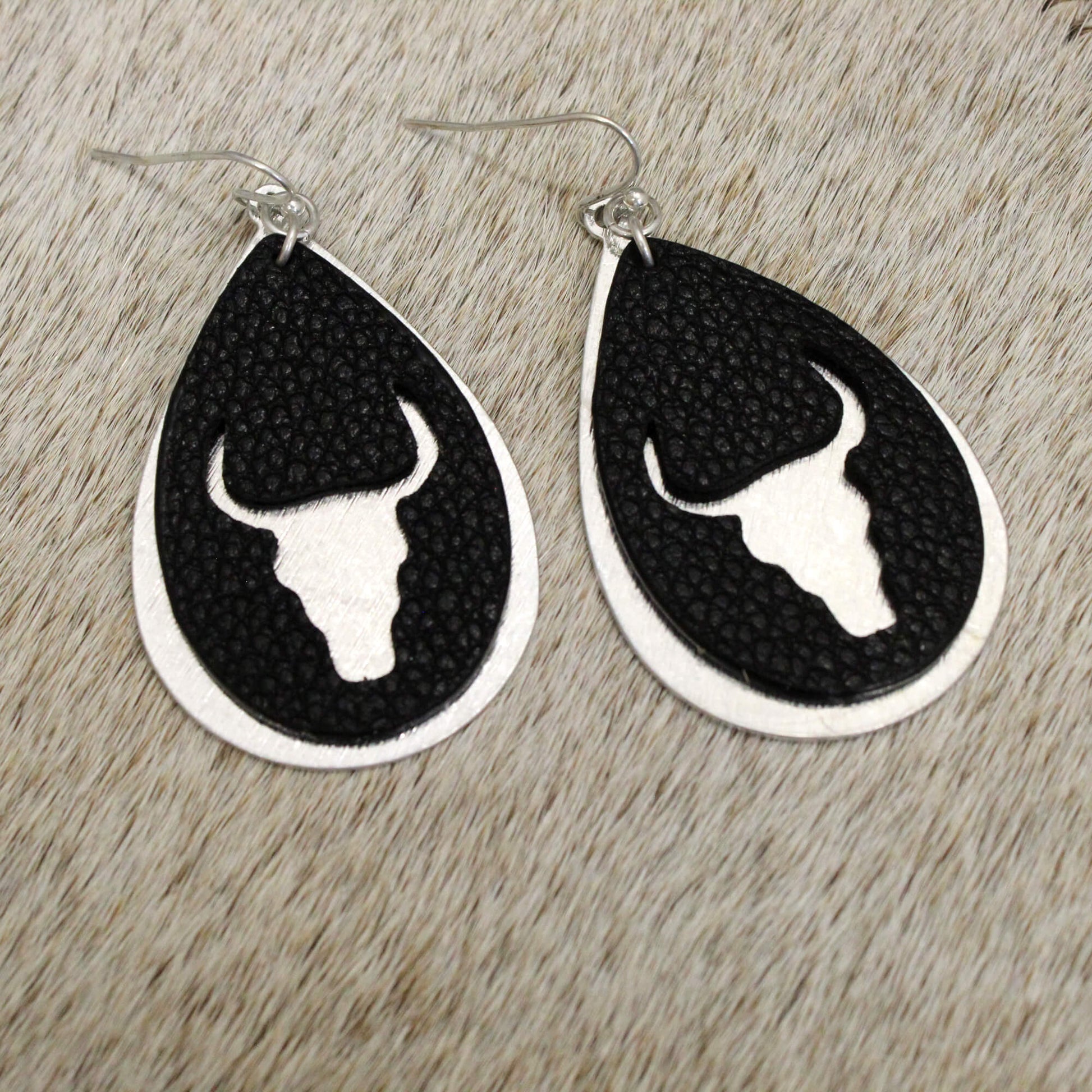 The striking skull silhouette creates an eye-catching focal point that's sure to turn heads. Elevate a simple tee and jeans or amp up a going-out ensemble - these earrings work for any occasion.