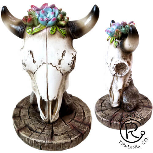 Yeehaw! Bring a touch of the wild west right into your home with this Skull Figurine with Flowers on Head. Give it a special place on a shelf, desktop, or windowsill to remind yourself or your favorite cowgirl to embrace your adventurous spirit every single day. It's perfect for any cowgirl's room or for anyone who loves the beauty of the great outdoors. 6 X 4 X 4