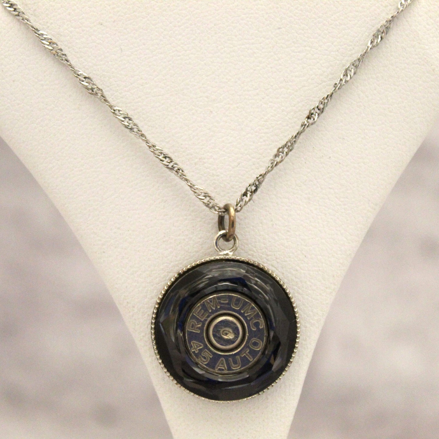 Make a statement with the eye-catching pendant, featuring a Smokey Grey Swarovski crystal with a glinting bullet inside. The unique medallion design is sure to get attention and compliments. The fine 16-18 inch silver chain allows you to wear it at multiple lengths to suit your style.