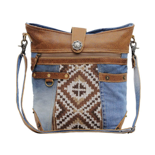 With its fashionable mix of textures and fabrics, this bag adds a touch of Western charm to any outfit. The generously-sized interior lets you carry all your daily essentials, while the over-the-shoulder strap keeps your hands free for on-the-go convenience.