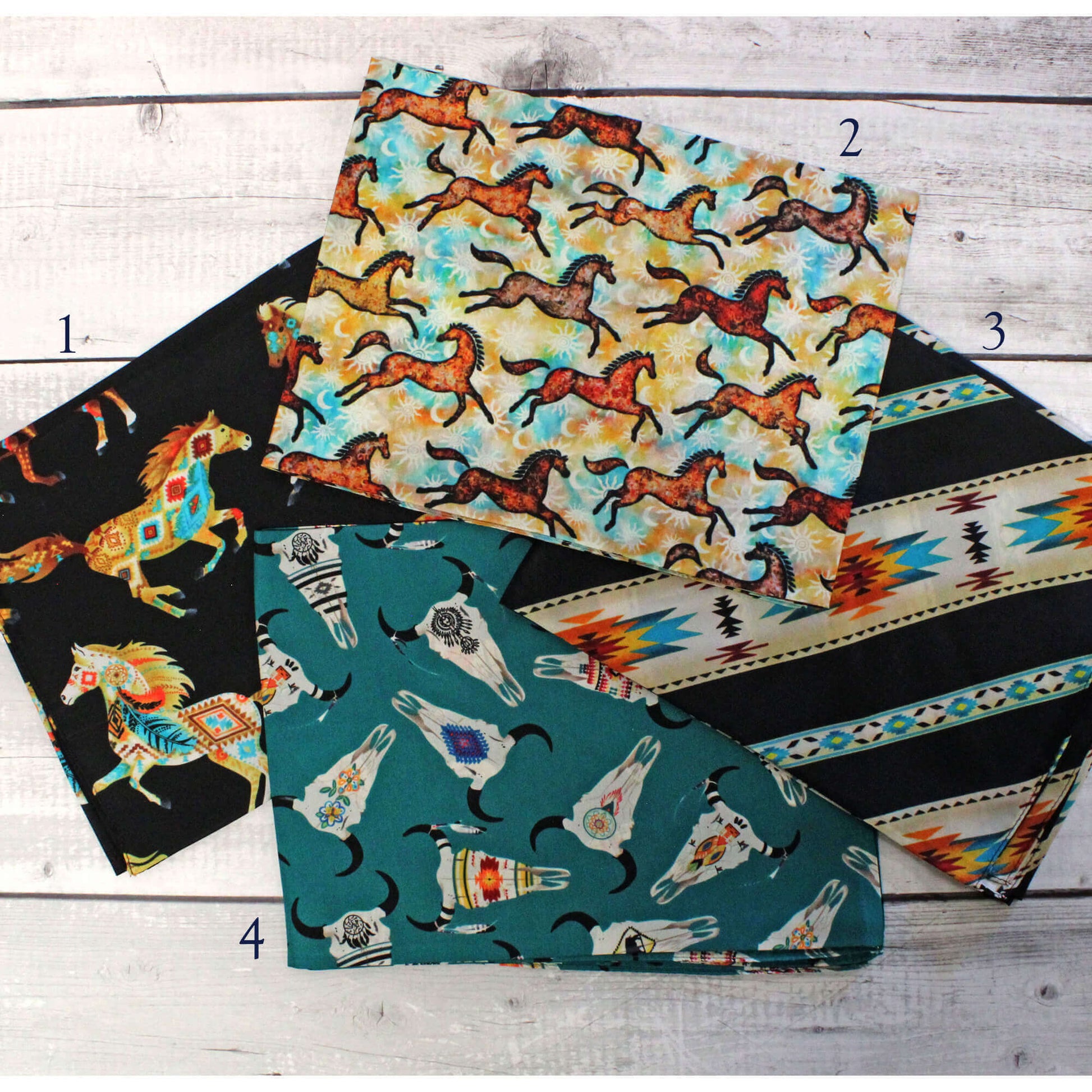 Four fabric swatches with different patterns on a wooden surface