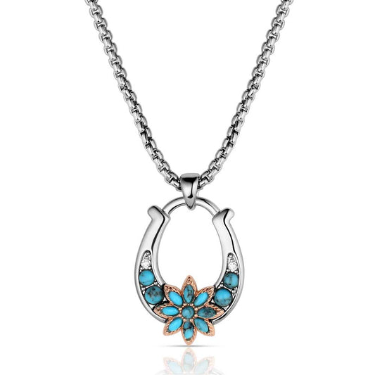Necklace with a horseshoe pendant featuring turquoise stones on a white background