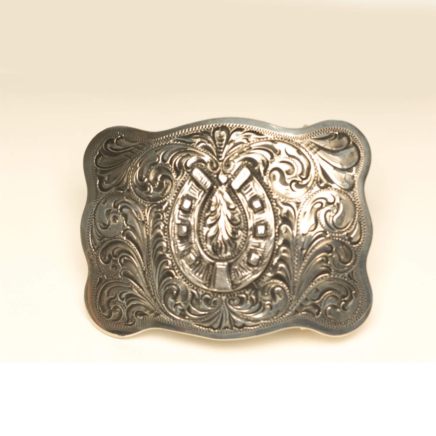 With its brilliant sterling silver shine and impressive hand tooled detail, this horseshoe buckle is a true work of art. The intricate horseshoe design pops against any belt and adds stylish flair to both casual and formal ensembles. It's made right here in the USA by expert silversmiths, ensuring remarkable quality that will last for generations.