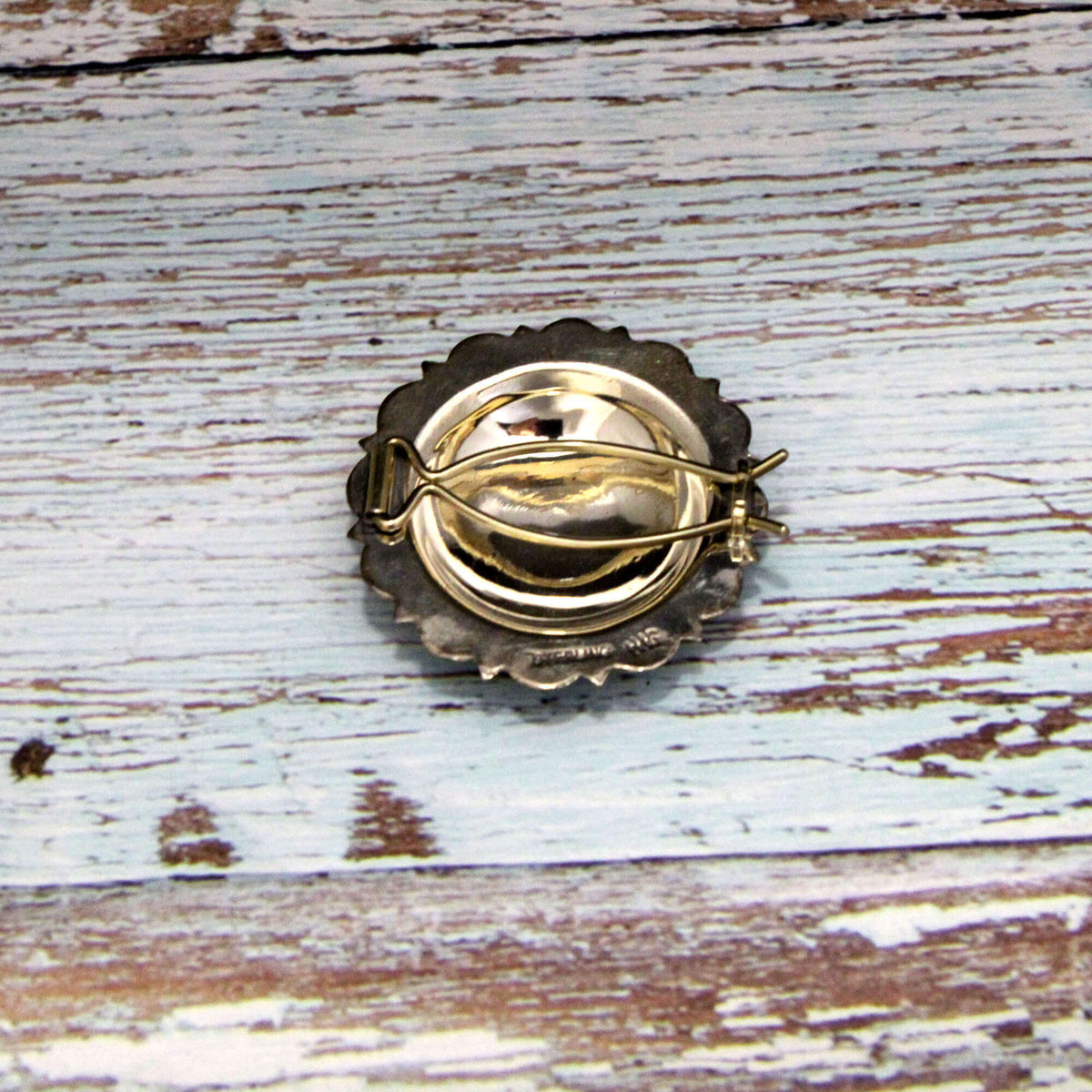 Back of Silver hair Barrette on a rustic wooden surface