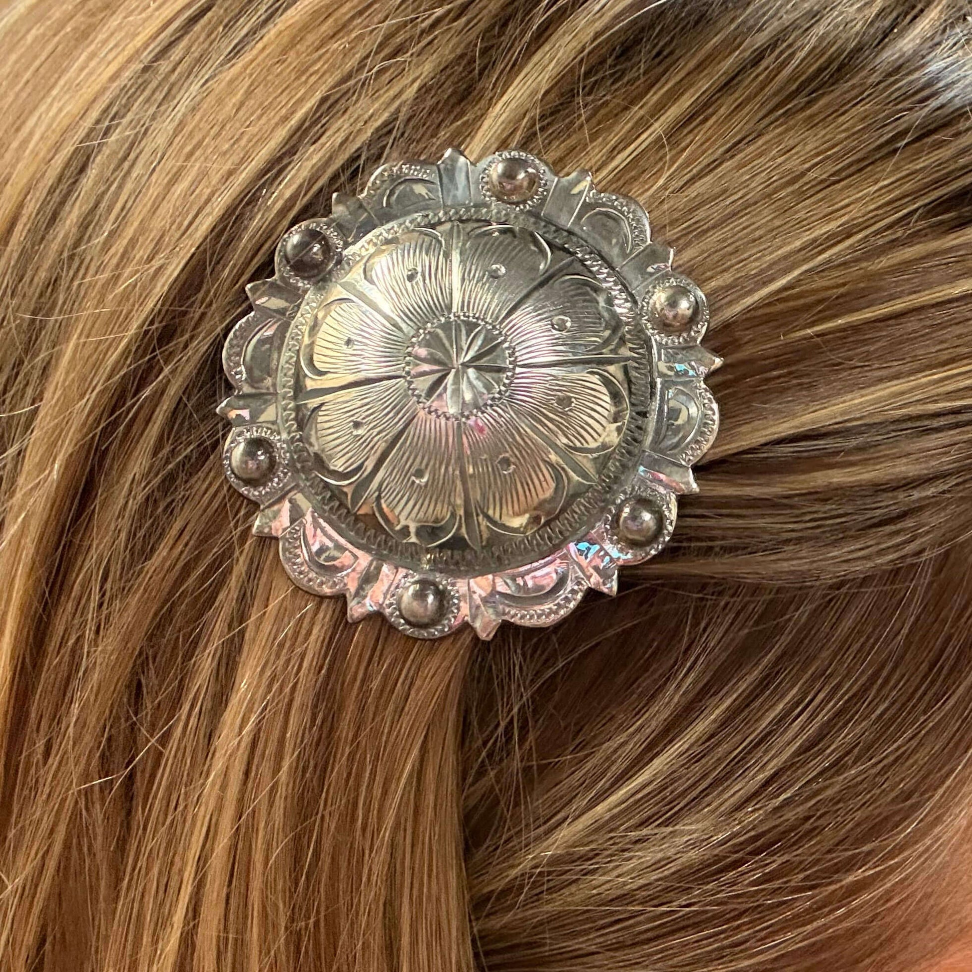 Close-up of a decorative hair clip on brown hair