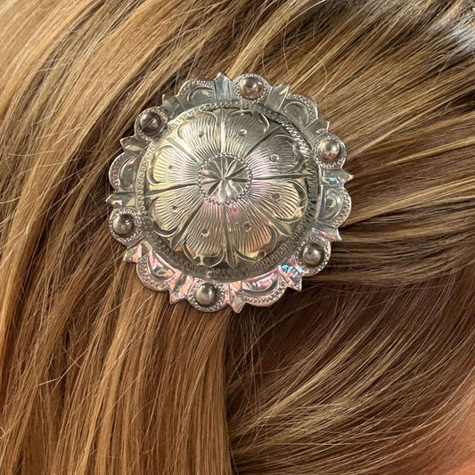 Close-up of a decorative hair clip on brown hair