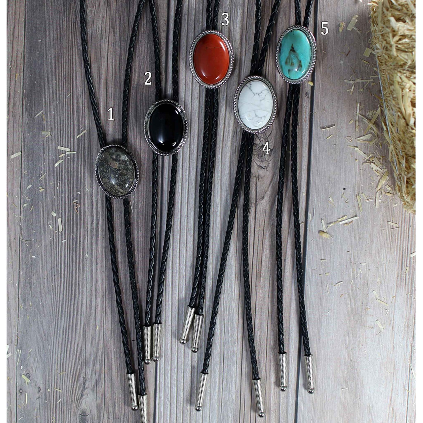 Add color to your western attire neckwear with these bolo ties. Get just the color you need or get a couple to have options. Oval with rope design edge on a black leather cord choose from brown, red, black, white, turquoise or red. Measures 1-1/4" by 1-1/2" on a 30" cord. 