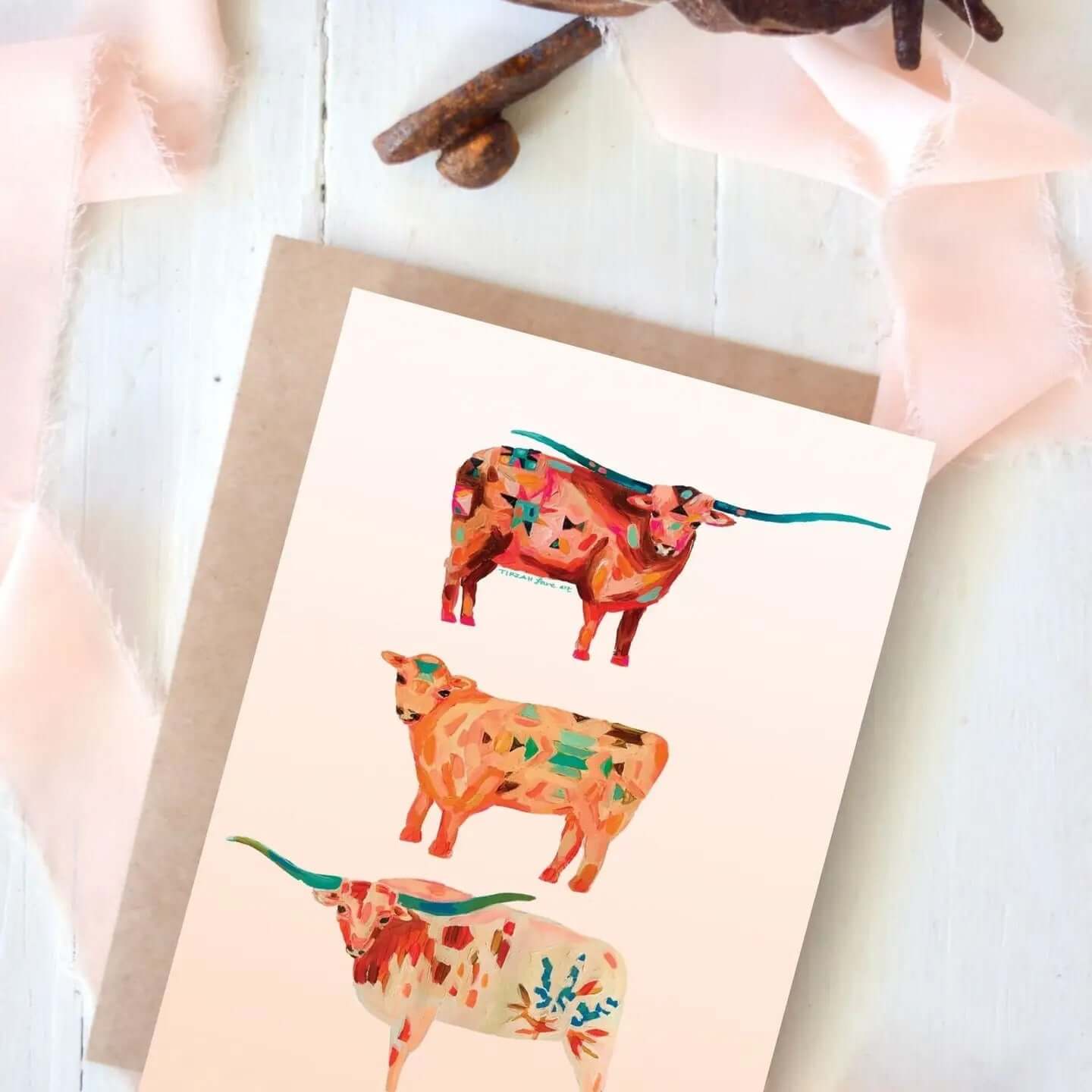 Cowgirl & Cowboy Western Greeting Cards Blank featuring colorful, illustrated longhorn cattle design on a light background.