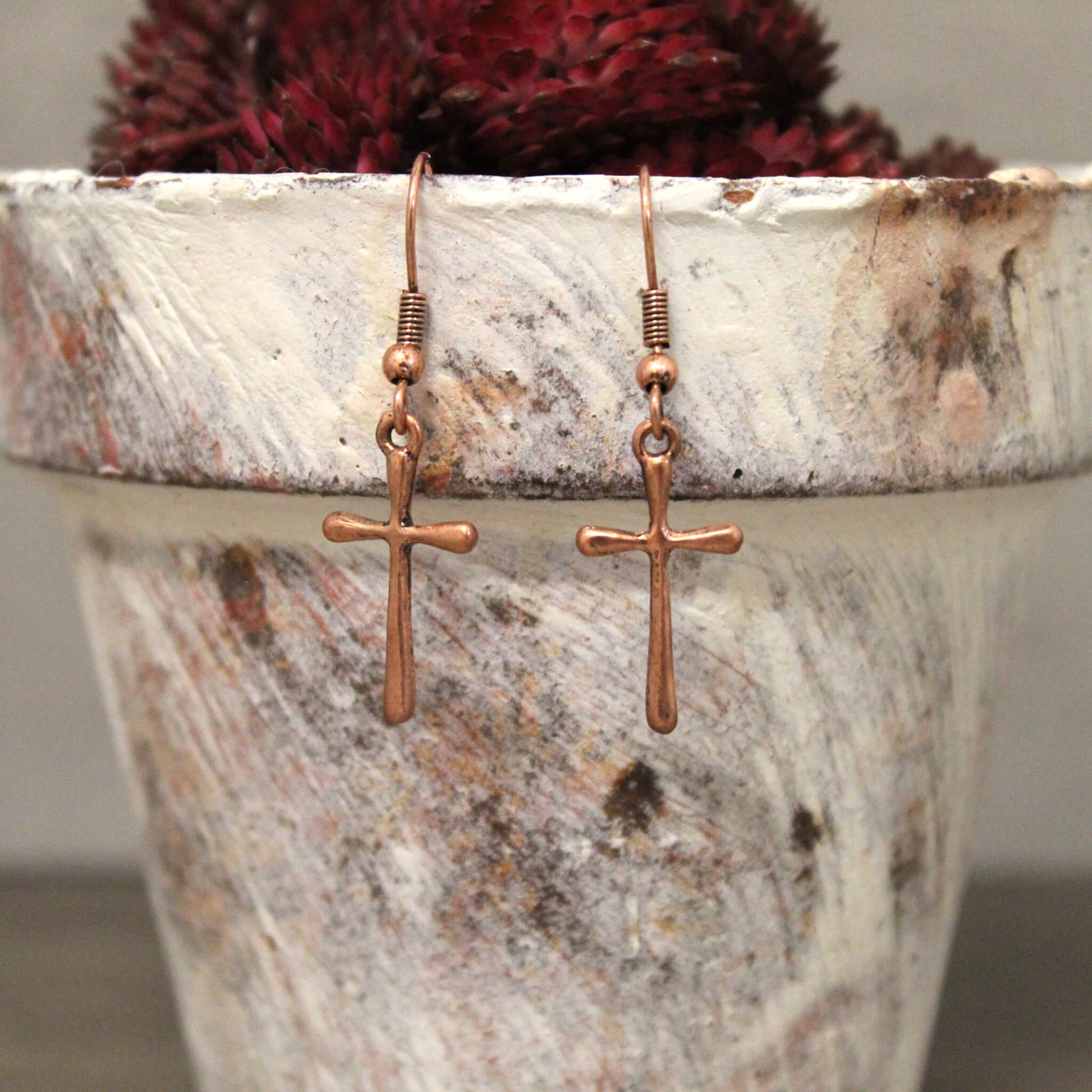 Antiqued copper cross dangle earrings. Petite, thin cross charm suspends from a rope copper ring. A nice gift for mom or a friend. Copper Cross earrings are the perfect complement to your Boho or western style. Approximately 1" by 3/8"