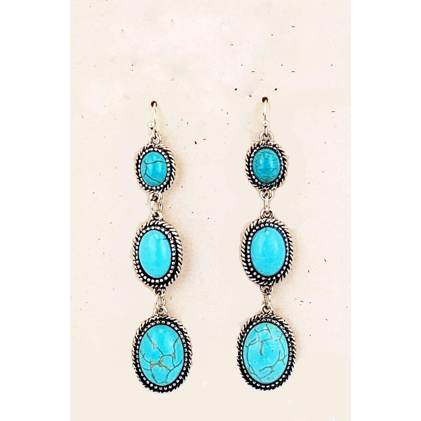 These long 3 Turquoise stone earrings are perfect for any occasion. &nbsp;The hypoallergenic ear wire holds 3 gradually increasing Turquoise stones. These earrings are ready for your night out. Measures 3″ from bottom of ear wire (1″ stones) to bottom of earring.