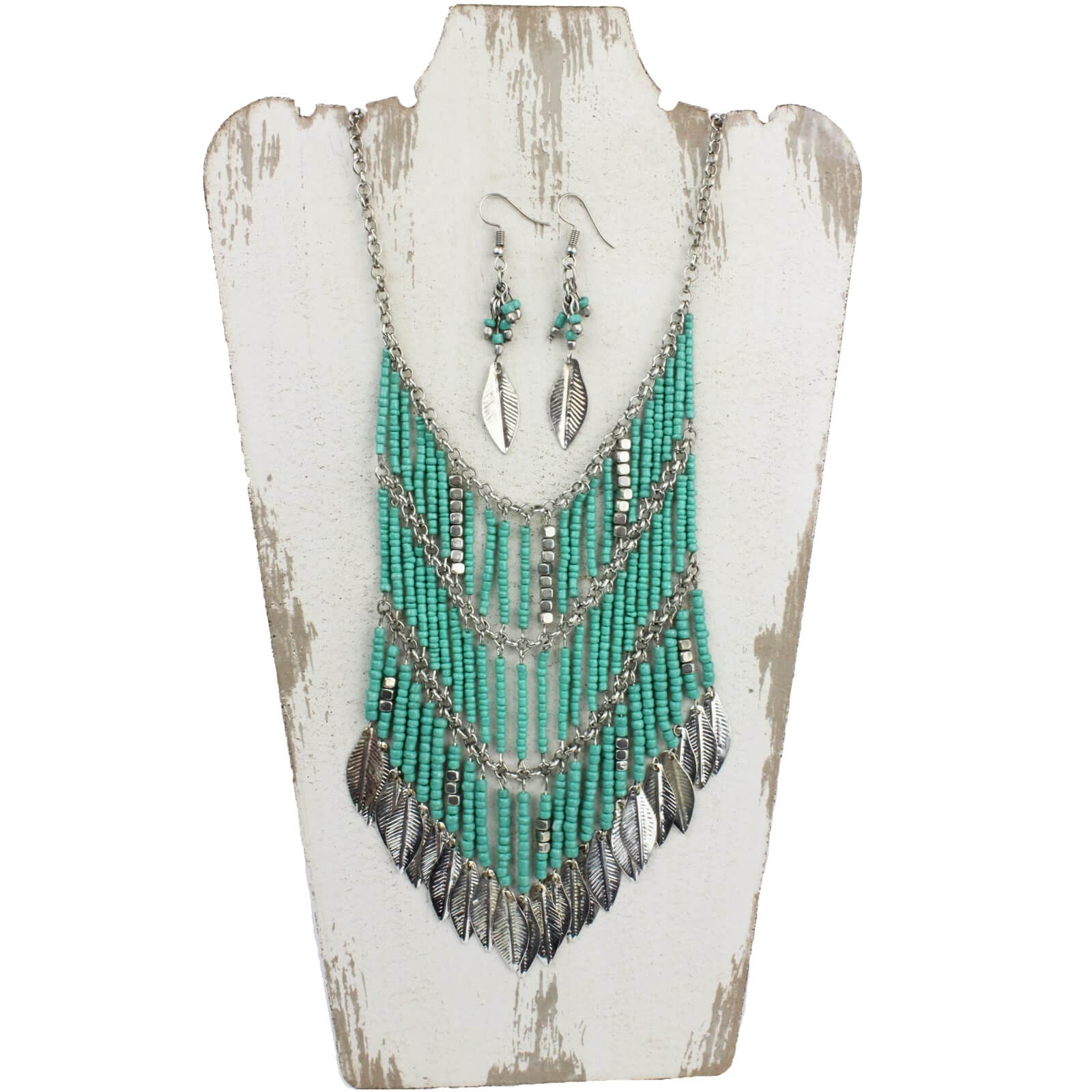 Teal and silver beads strung together to form the shape of a shield with silver feather accents. Necklace measures 17″ with lobster claw clasp and chain extension. Shield measures 4.50″ wide by 4″ long. Matching earrings measure 1.75″ from bottom of hypoallergenic ear wire to bottom of earring.