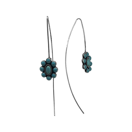 A pair of silver-toned dangle earrings with a cluster of turquoise blue-green flowers at the bottom of each curved wire, shown on a plain white background.