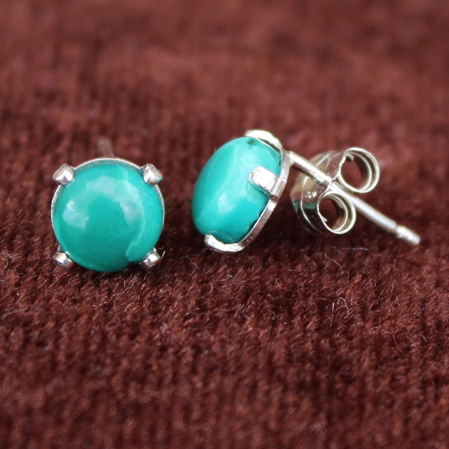 These turquoise earrings are made with high grade turquoise nuggets in shades of deep blues and greens in sterling silver setting. Compliment these with our turquoise nugget necklace. Measures ¼” Diameter. Handmade in USA. 