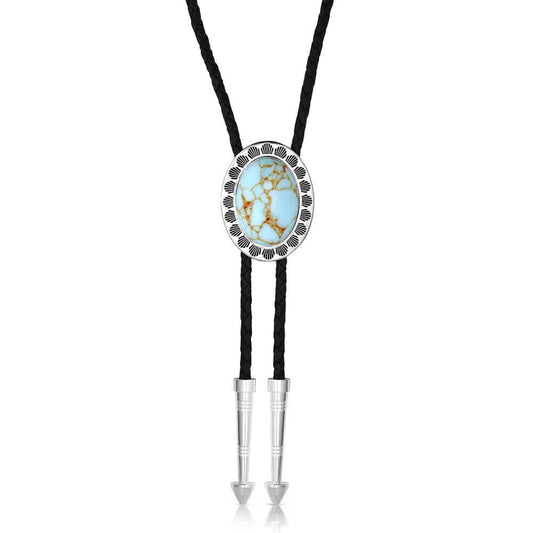 Elevate your style with the Turquoise Waters Bolo Tie. This bolo tie features a stunning oval shaped light turquoise stone. A silver tone border with simple etching encircles the turquoise stone. The black braided leather cord is nicely weighted with two silver tone arrow pointed tips. Stone color will vary. Made of silver over brass. Crafted turquoise. Paint. Protective coating. Leather cord. Made in USA