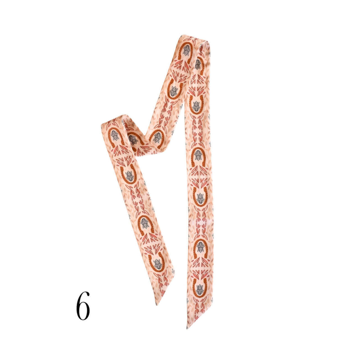 A patterned twilly scarf with a peach and rust orange design featuring small circular medallions and geometric details, shown on a plain white background with a black number '6' in the lower-left corner.