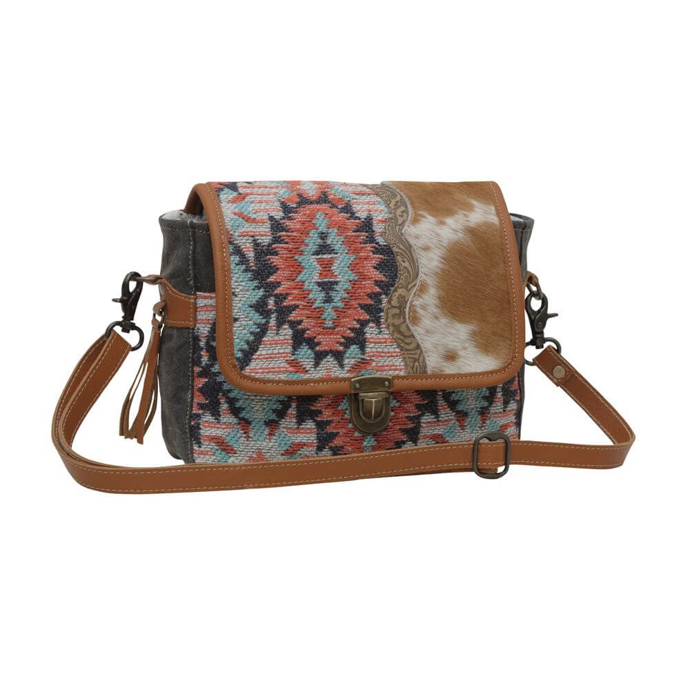 Fun-loving ladies who appreciate statement accessories will love the way this artistic cowgirl purse elevates their look. Pair it with everything from jeans to dresses to add an unexpected dash of Western flair. Measures 10.5" x 8" x 3" Made in India