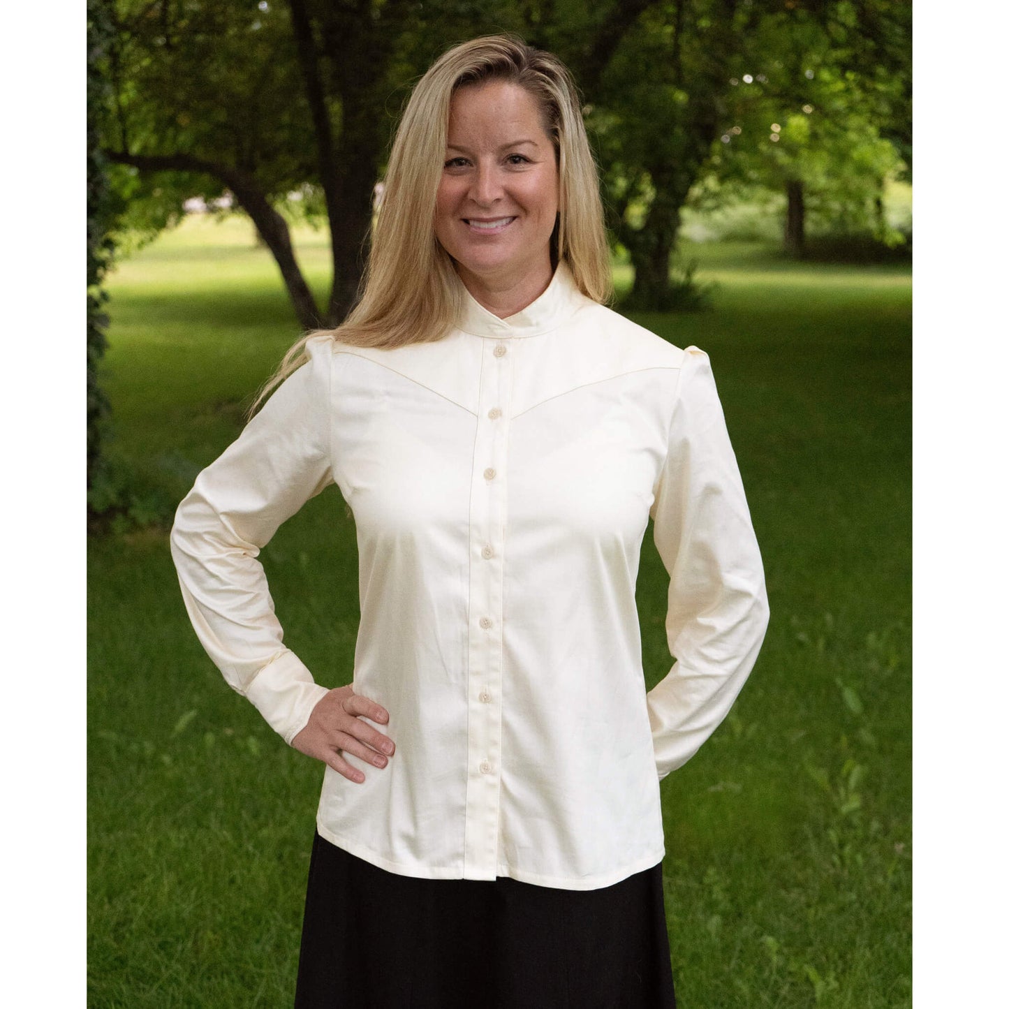 Our new favorite Cattle Kate blouse has a collar that buttons for a perfect high Victorian neckline. Collar can highlight a vintage brooch or classy up-do.  The angled yoke and cuffs have delicate lace to add a contemporary take on the Victorian style blouse. A unique tuck in the back gives just the right fit. 100% Cotton Ivory Sateen. Made in USA.