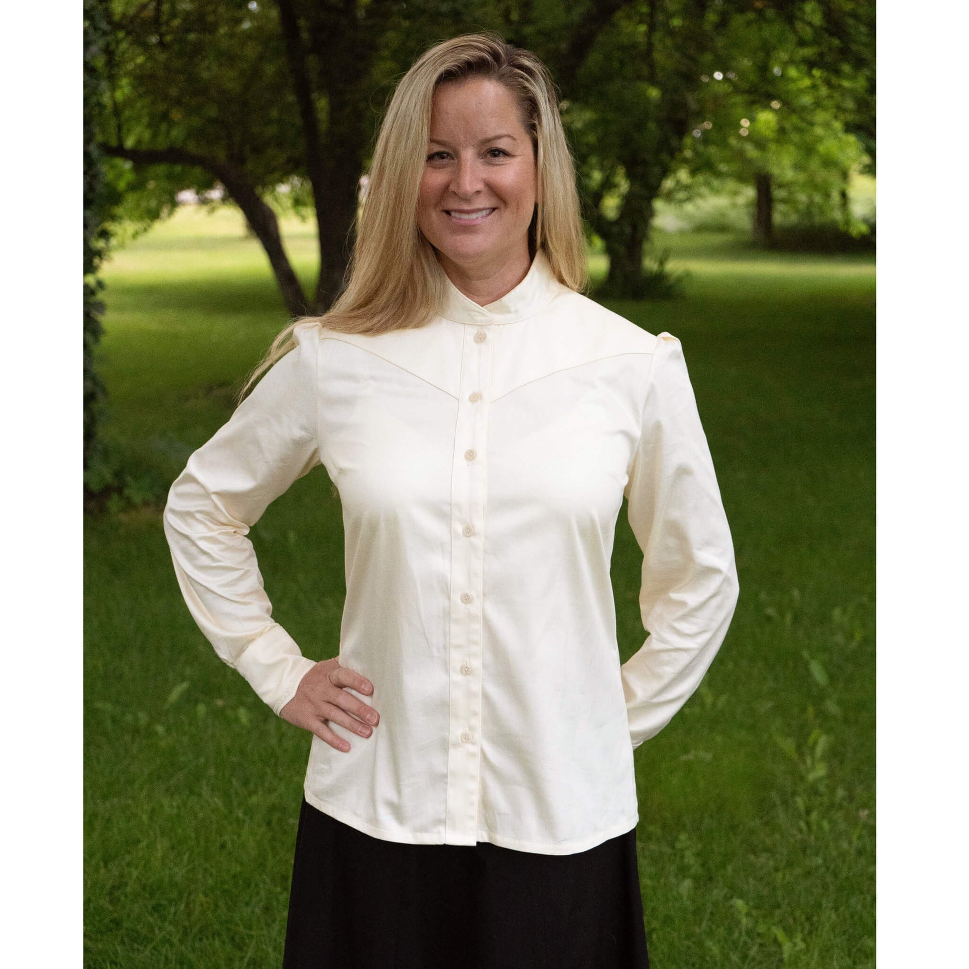 Our new favorite Cattle Kate blouse has a collar that buttons for a perfect high Victorian neckline. Collar can highlight a vintage brooch or classy up-do.  The angled yoke and cuffs have delicate lace to add a contemporary take on the Victorian style blouse. A unique tuck in the back gives just the right fit. 100% Cotton Ivory Sateen. Made in USA.