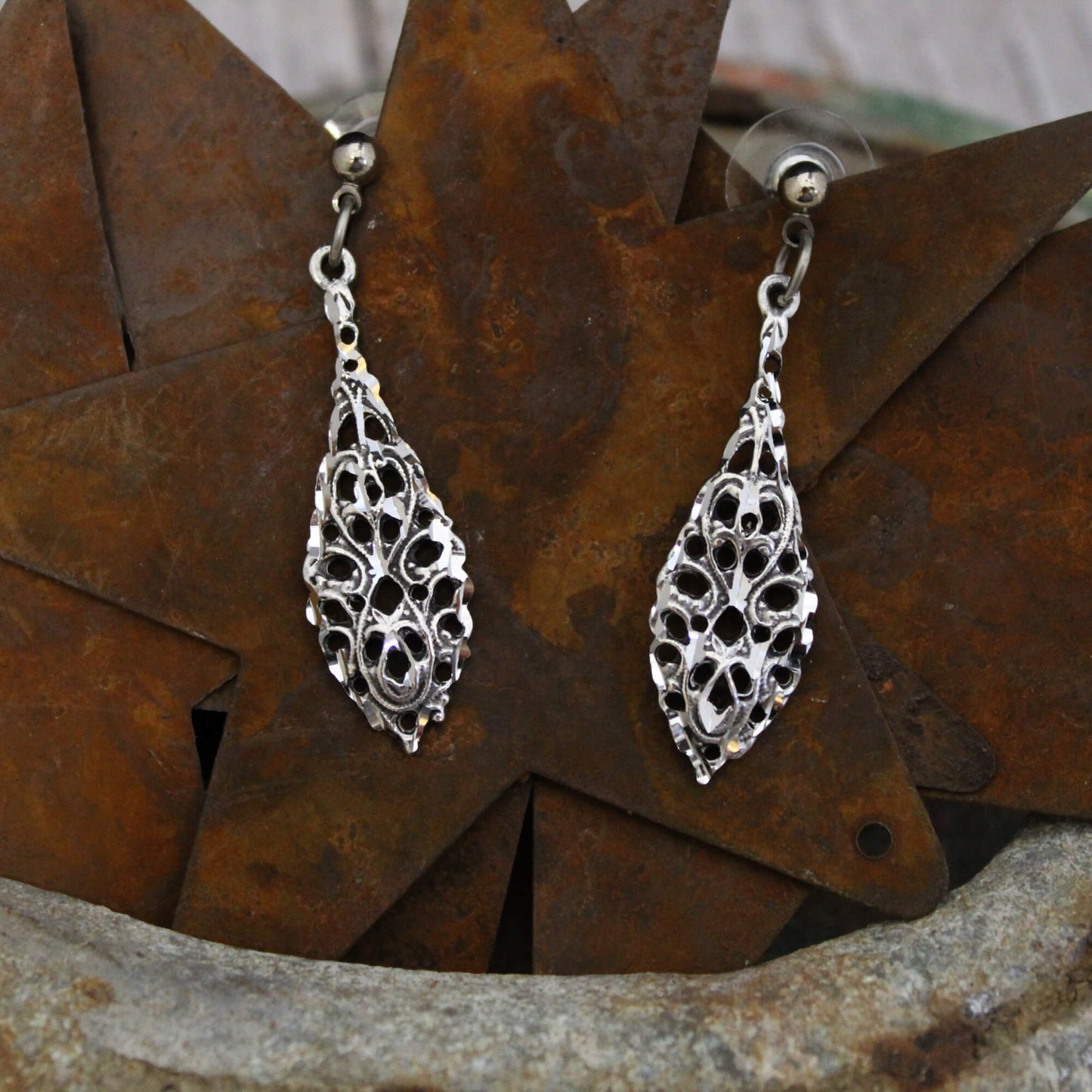 Step back in time with the striking beauty of these Victorian inspired dangle teardrop earrings. Featuring a vintage pewter design with diamond cut detailing, these 1-1/2” long earrings radiate refined elegance.