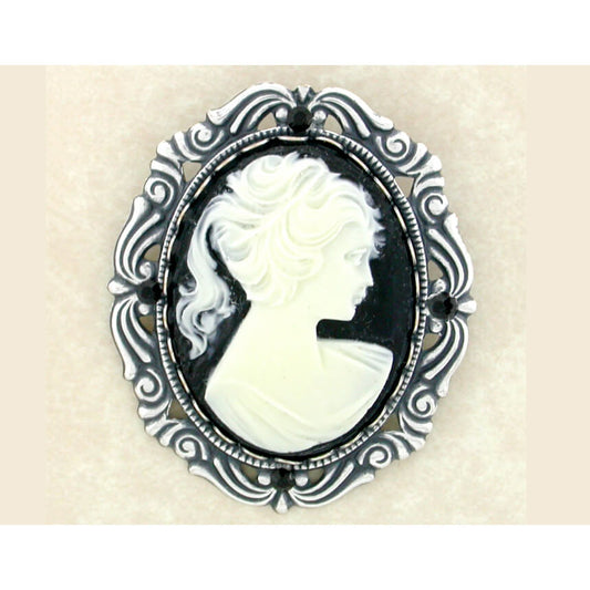 Cameo brooch with black and white design on a beige background