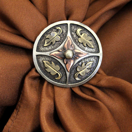 Decorative button with floral design on brown fabric