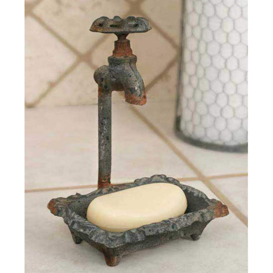 Cast metal soap dish features a floral pattern on the base. Measures 6" wide and 8½" tall. Textured dark grey finish with rust-colored accents. Water spout knob is cast and does not spin.