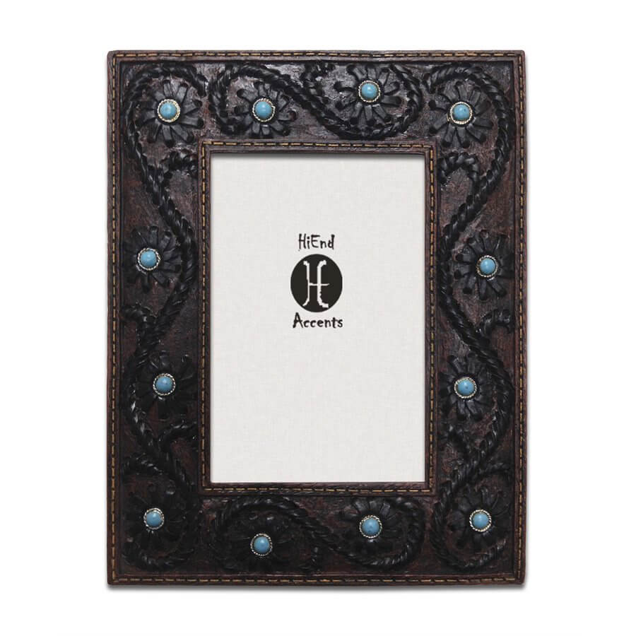 Created from high quality resin and hand painted, this picture frame of scrolling tooled faux leather with a stitched edge has turquoise beads that accent floral details. This 4" x 6" photo frame will add a western touch to your décor. Can be utilized with either vertical or horizontal photographs. Back has swing tabs for easy installation, and a thick layer of glass protects your image.