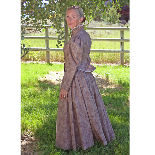 You can wear this finely made walking skirt and jacket almost anywhere. Skirt has two side pockets and is fully gathered in back for a bustle effect. The fitted jacket is detailed with cream piping. Skirt is frontier length, approximately 35" long. Wear it with our petticoat sold separately. Offered in navy, brown or moss. Made of 100% Cotton. Made in USA.