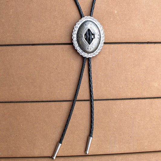 Dress up your western cowboy garb with this simple but unique men's western bolo tie. This slotted style Concho allows the bolo tie to weave through it.