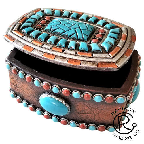 This exquisite Western Decorative Trinket Box features a striking turquoise and red design, perfectly complemented by a beautiful turquoise stone. Measuring 2 x 4 x 3.5 inches, it serves as an elegant storage solution for small treasures while adding a touch of rustic charm to any decor. Ideal for collectors and those who appreciate unique craftsmanship, this trinket box is both functional and visually appealing.