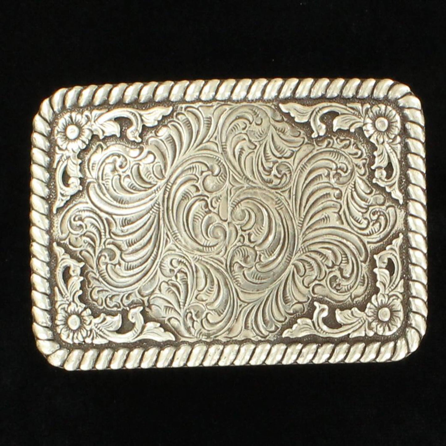 This silver buckle features an ornate rope edge framed in a floral scroll. Measures 3 ½" x 2 ¼".