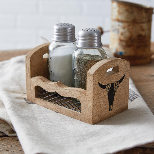 Cork salt and pepper shaker set with decorative bull skull design on a wooden surface.