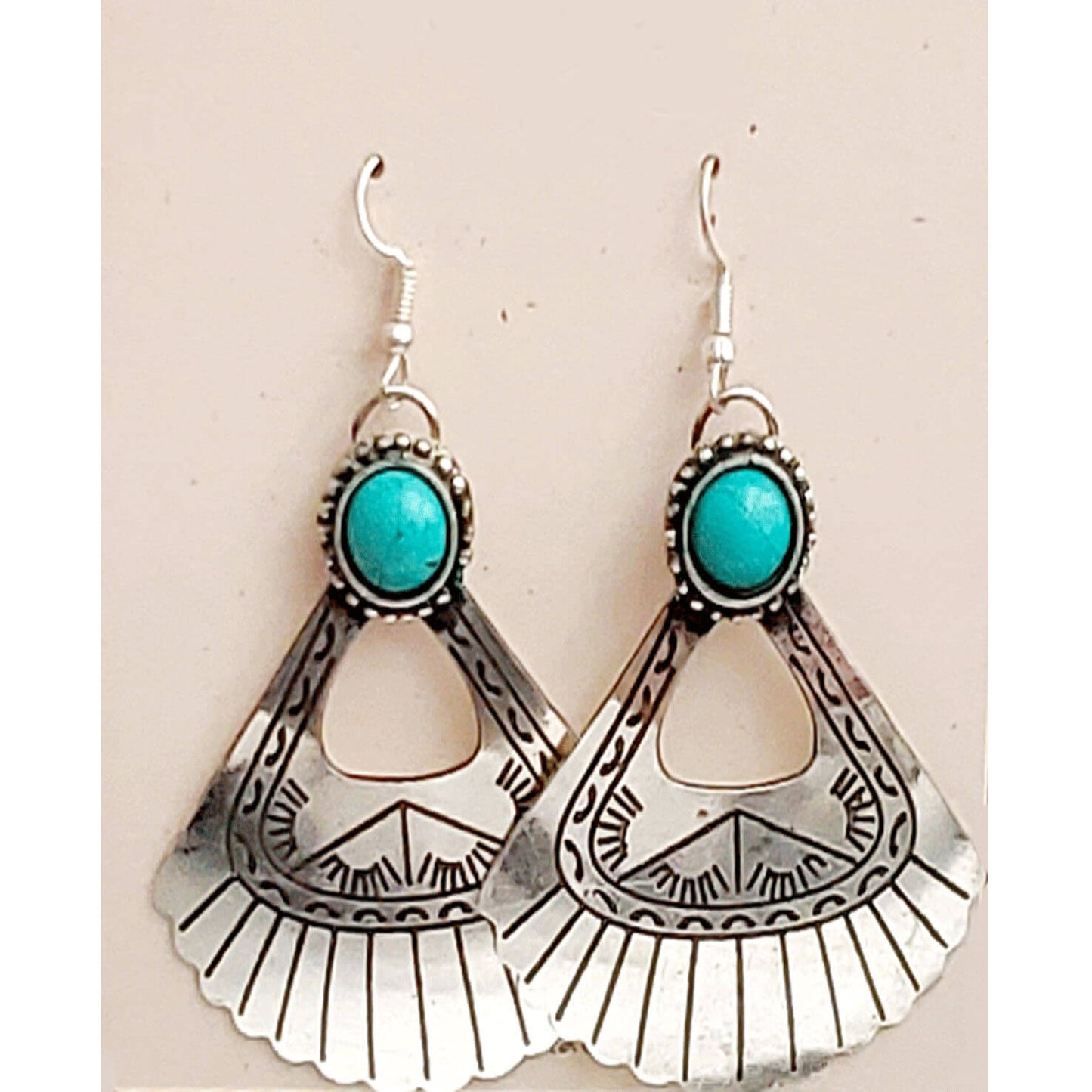 Unique and light-weight at the same time! What a combo! Native American inspired design with mag turquoise cabochon on a triangle-shape metal cutout. Earring measures 2.25″ from bottom of hypoallergenic ear wires to bottom of scalloped edge.